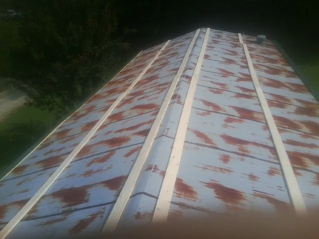 Rusted metal roof panels with new wood purlins before replacement — Storm Damage Roof Repair in Pittstown by Roofing Brothers